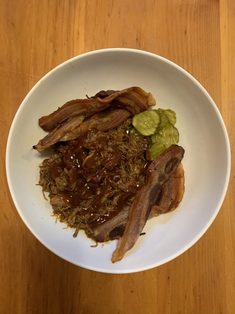 Image shows a bowel of slow-cooked pork and bacon from my local farm.