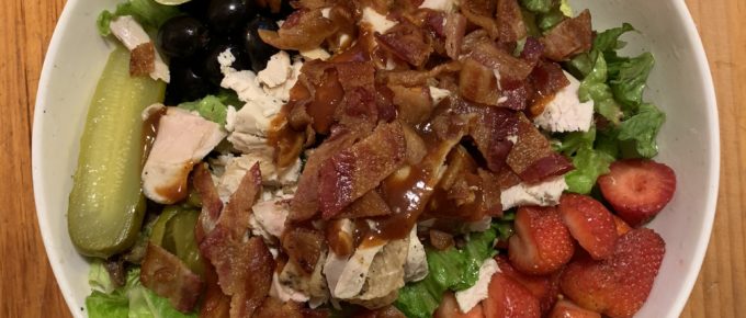 Picture of a big salad in a white bowl.