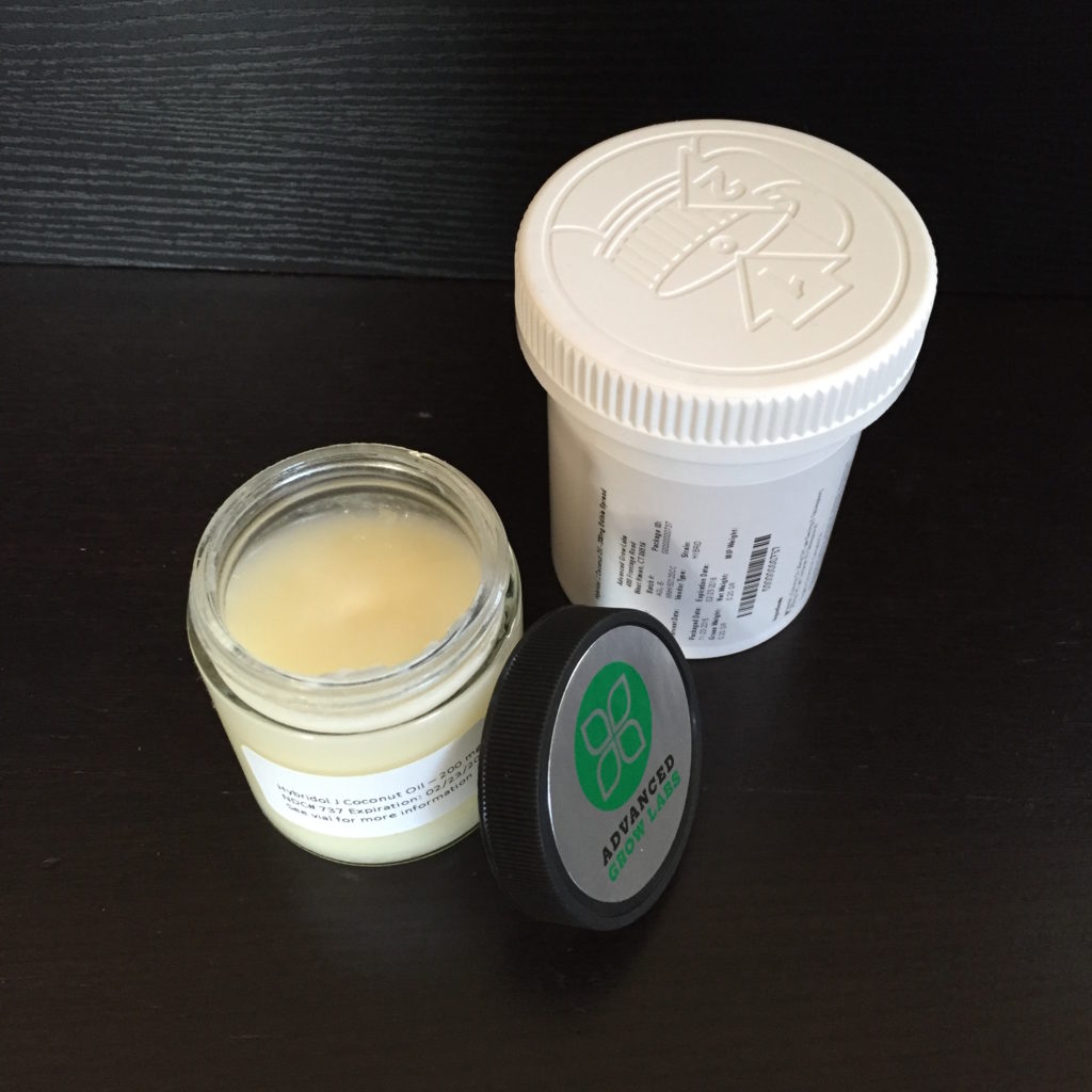 Container of marijuana-infused coconut oil. Product is AGL Hybridol J