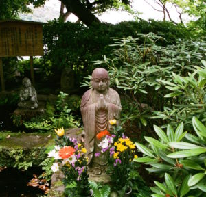 Statues of monks in meditation in a Japanese garden