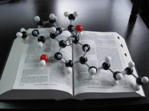 A 3-D molecular model of THC sitting on top of the Merck Index opened to the entry for THC.
