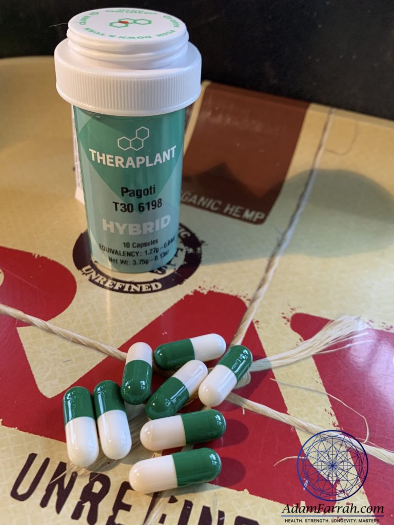 A number of green and white capsules containing medical marijuana oil.
