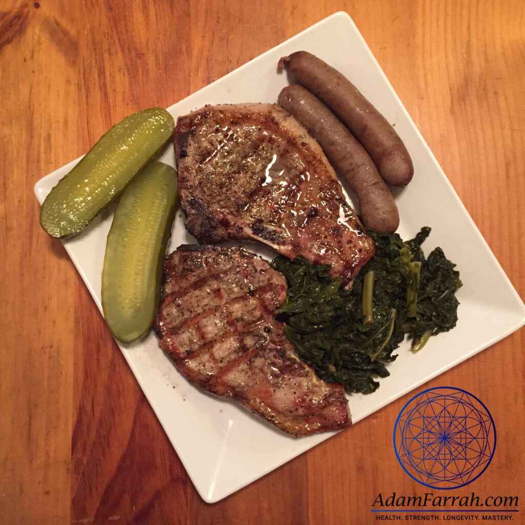 Grilled pork chops, braised kale, sausages and pickles.